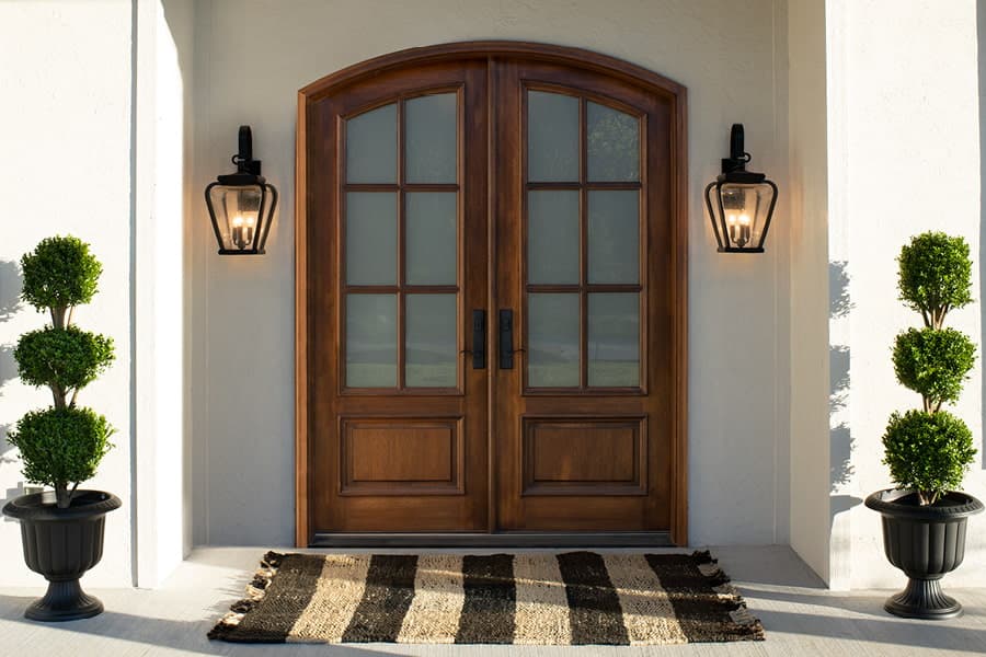 Traditional arched wooden double entrance door with glass inserts