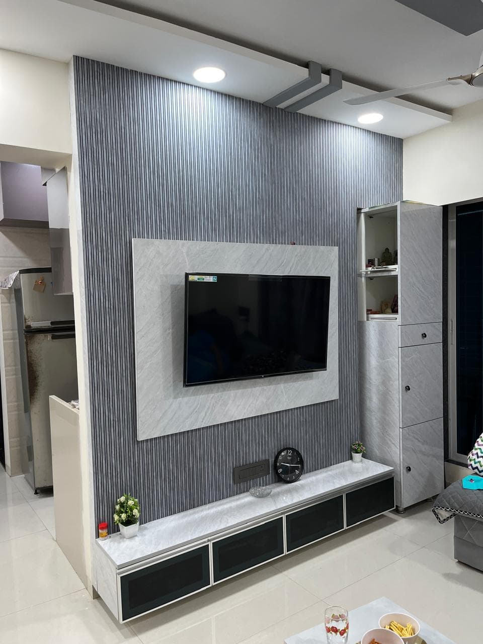 Fluted panel TV unit with marble facing