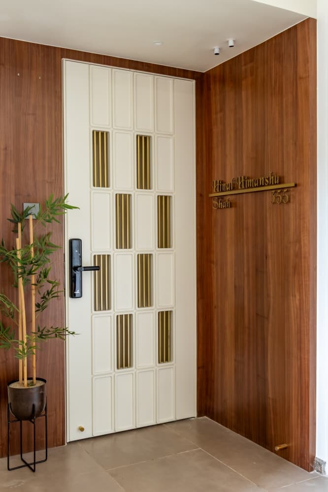 Contemporary wooden safety door with vertical metallic gold accent panels